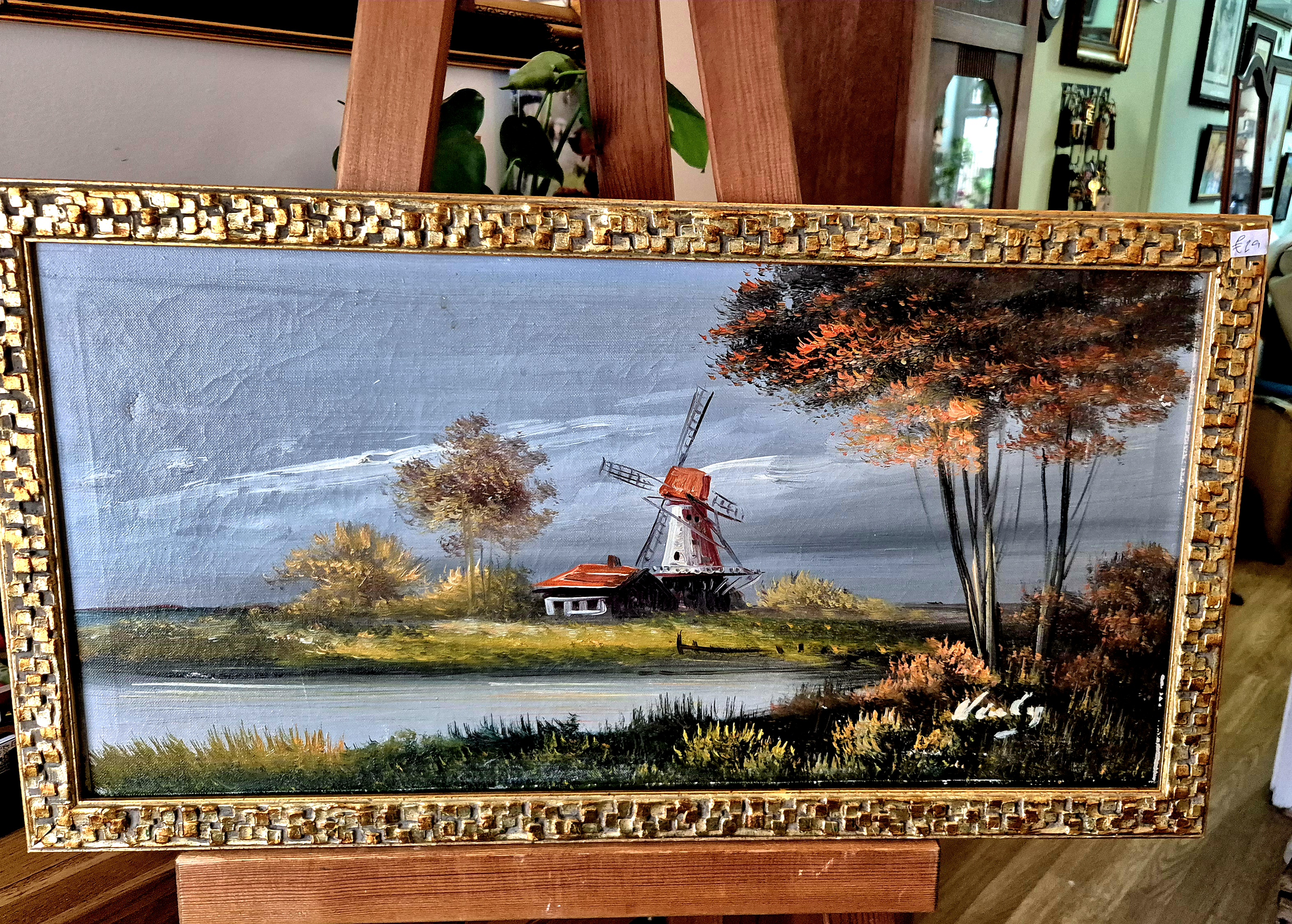 This is a decorative mid-20th-century style landscape oil pa